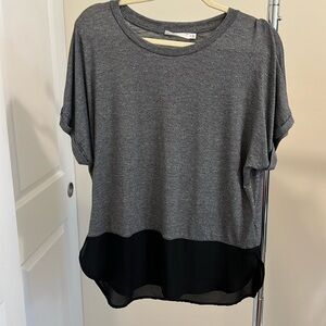 Lush grey shirt with black sheer trim at bottom.